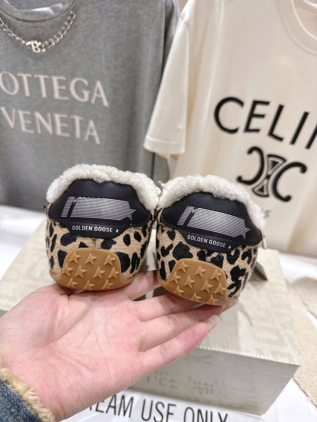 Back view of leopard-print sneakers with sherpa collar and Golden Goose heel detail