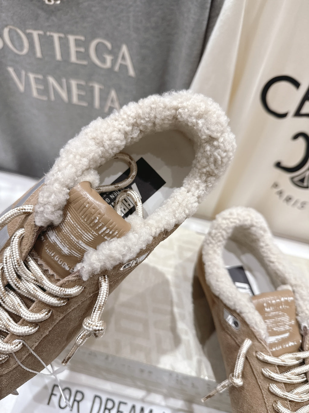 Golden Goose tan suede sneaker close-up, lace-up with plush collar and silver laces