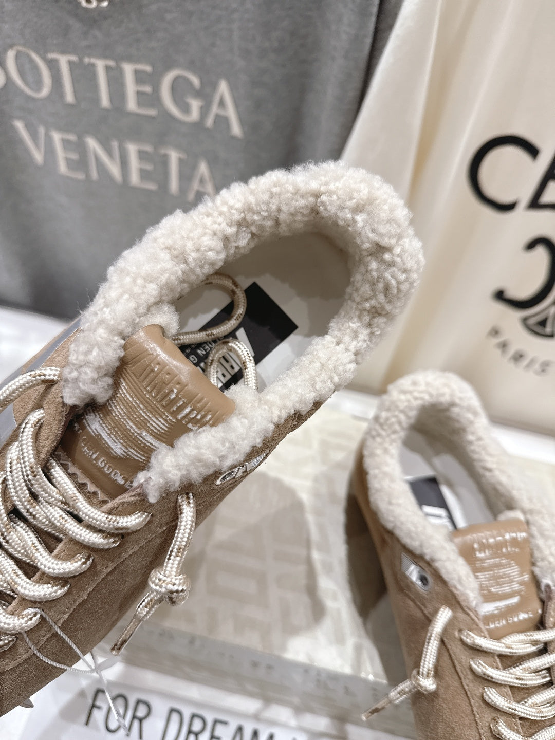 Golden Goose tan suede sneaker close-up, lace-up with plush collar and silver laces