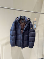 Dark hooded puffer jacket with open front showing patterned inner lining.