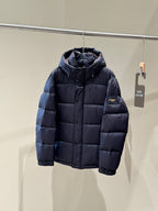Dark hooded puffer jacket with zipper front and small Fendi logo patch on chest.