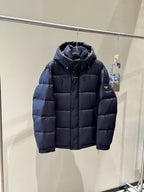 Dark hooded puffer jacket with zipper front and quilted diamond stitching.