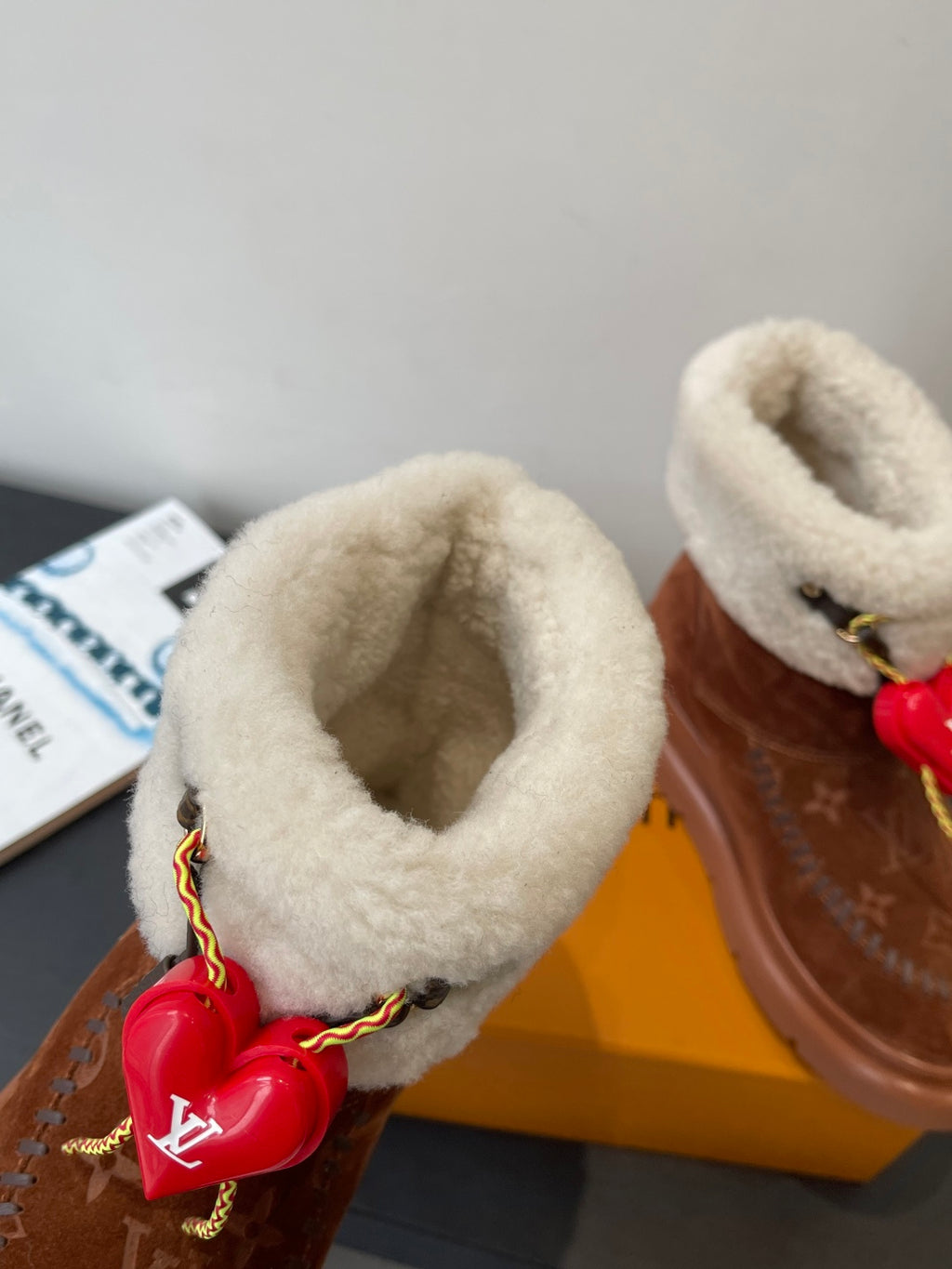 Louis Vuitton monogram suede ankle boots with shearling cuffs and red heart charm detail
