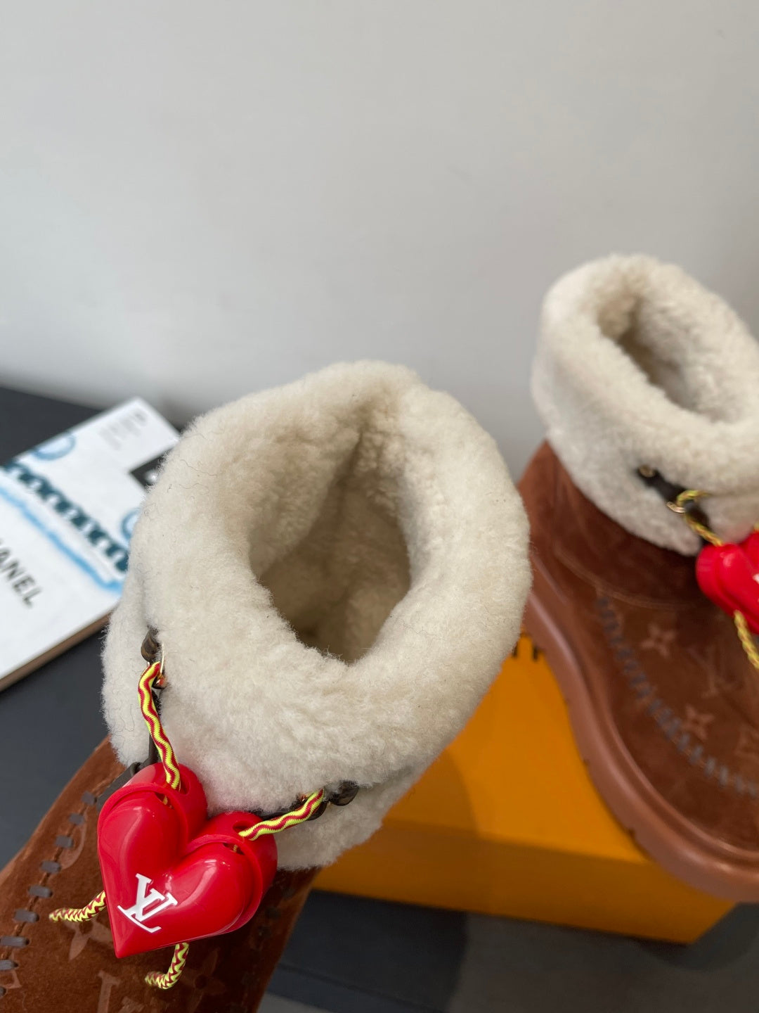 Louis Vuitton monogram suede ankle boots with shearling cuffs and red heart charm detail