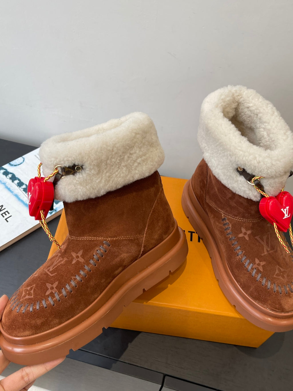 Louis Vuitton monogram suede ankle boots with shearling trim and red heart keychain