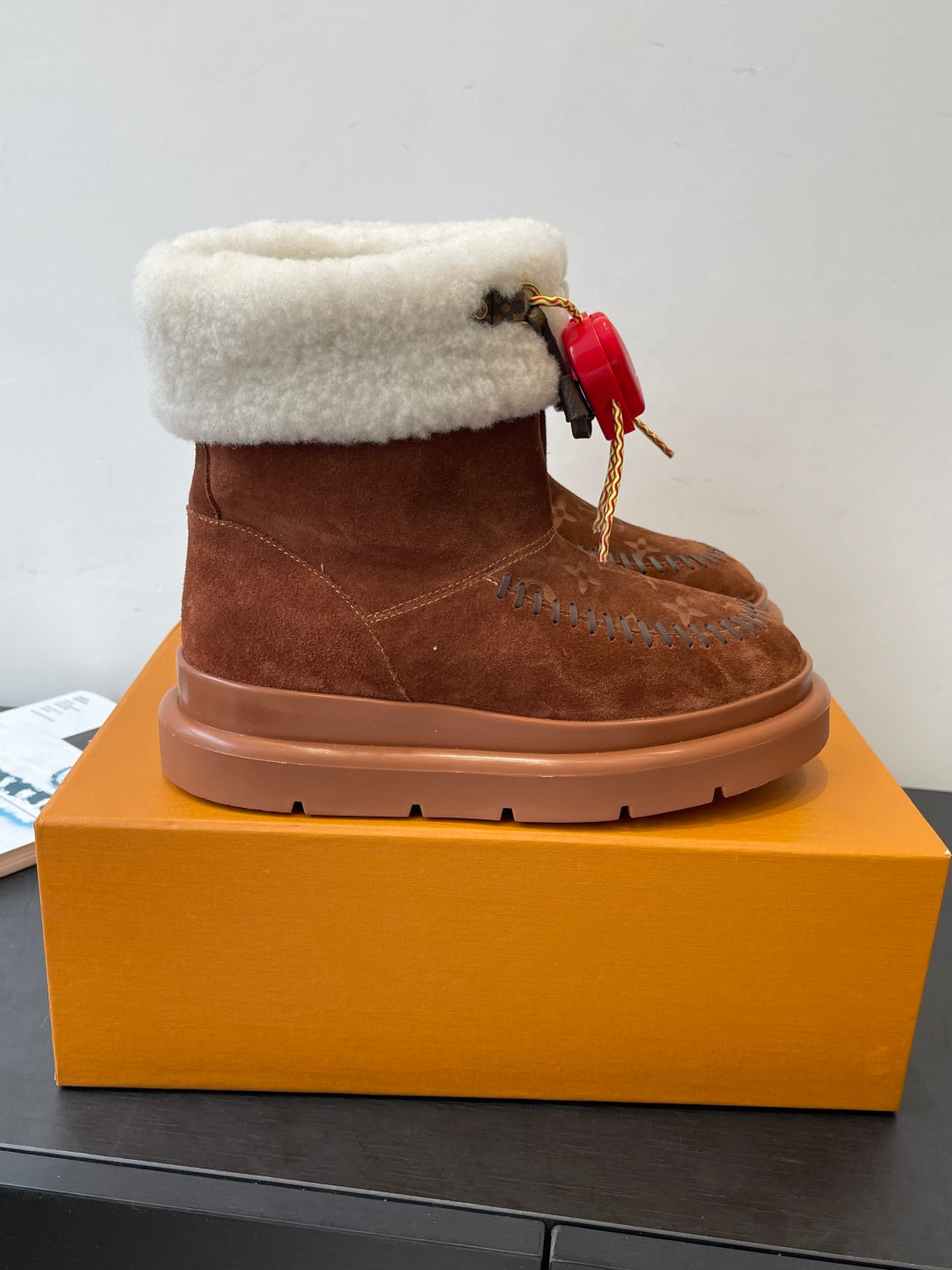 Louis Vuitton monogram suede ankle boots with shearling cuff and red heart tie detail