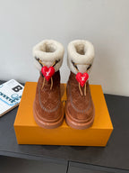 Louis Vuitton monogram suede ankle boots with shearling cuffs and red heart charms