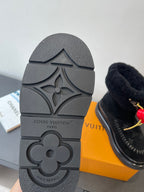 Black rubber sole of monogram ankle boot with molded Louis Vuitton logo