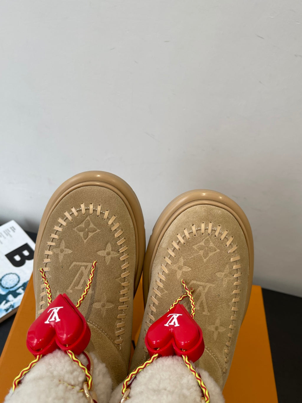 Louis Vuitton unisex tan suede shearling boots, top view with red heart charm tassels