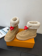 Louis Vuitton unisex tan suede shearling boots, angled view with red heart charm
