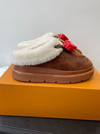 Brown suede slip-on shoe with cream shearling strap and red heart LV charm