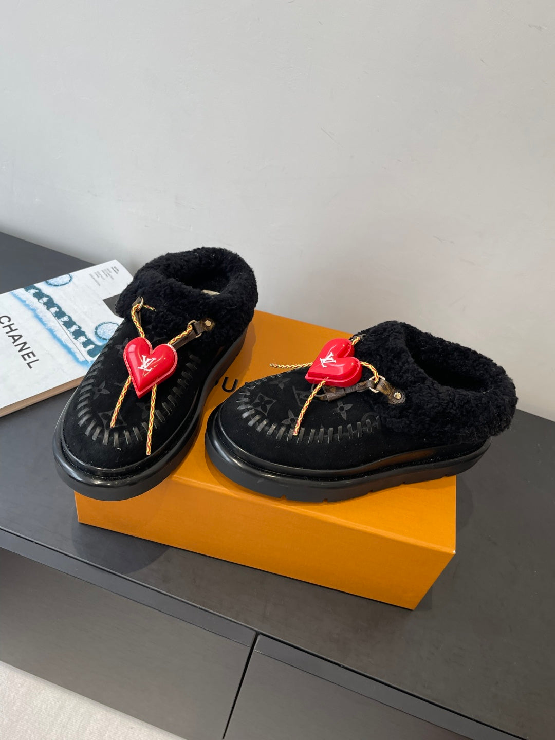 Black shearling slip-on shoes with red heart LV charms and braided cord laces