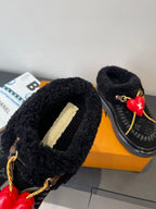 Black shearling upper detail with gold LV logo plaque and red heart charm
