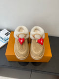 Shearling-lined tan slip-on shoes with gold chain trim and red heart charm details