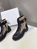 Pair of black lace-up ankle boots with plaid side panels and chunky sole