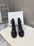 Black lace-up ankle boots with plaid side panels and gold-tone logo hardware