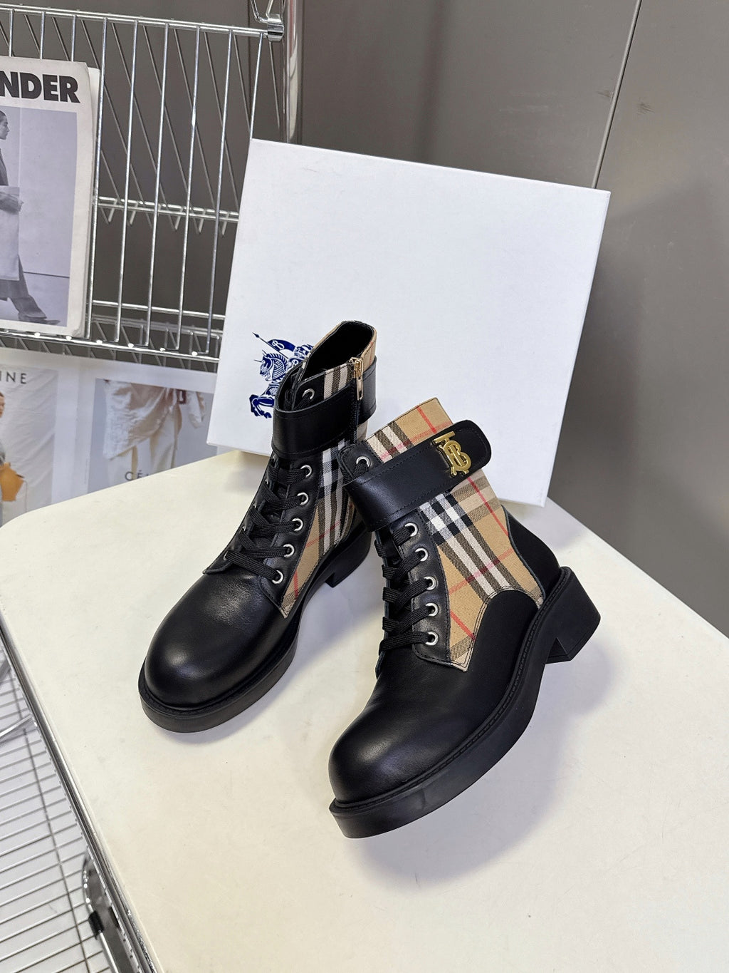 Black lace-up ankle boots with tan, black, and red check side panels