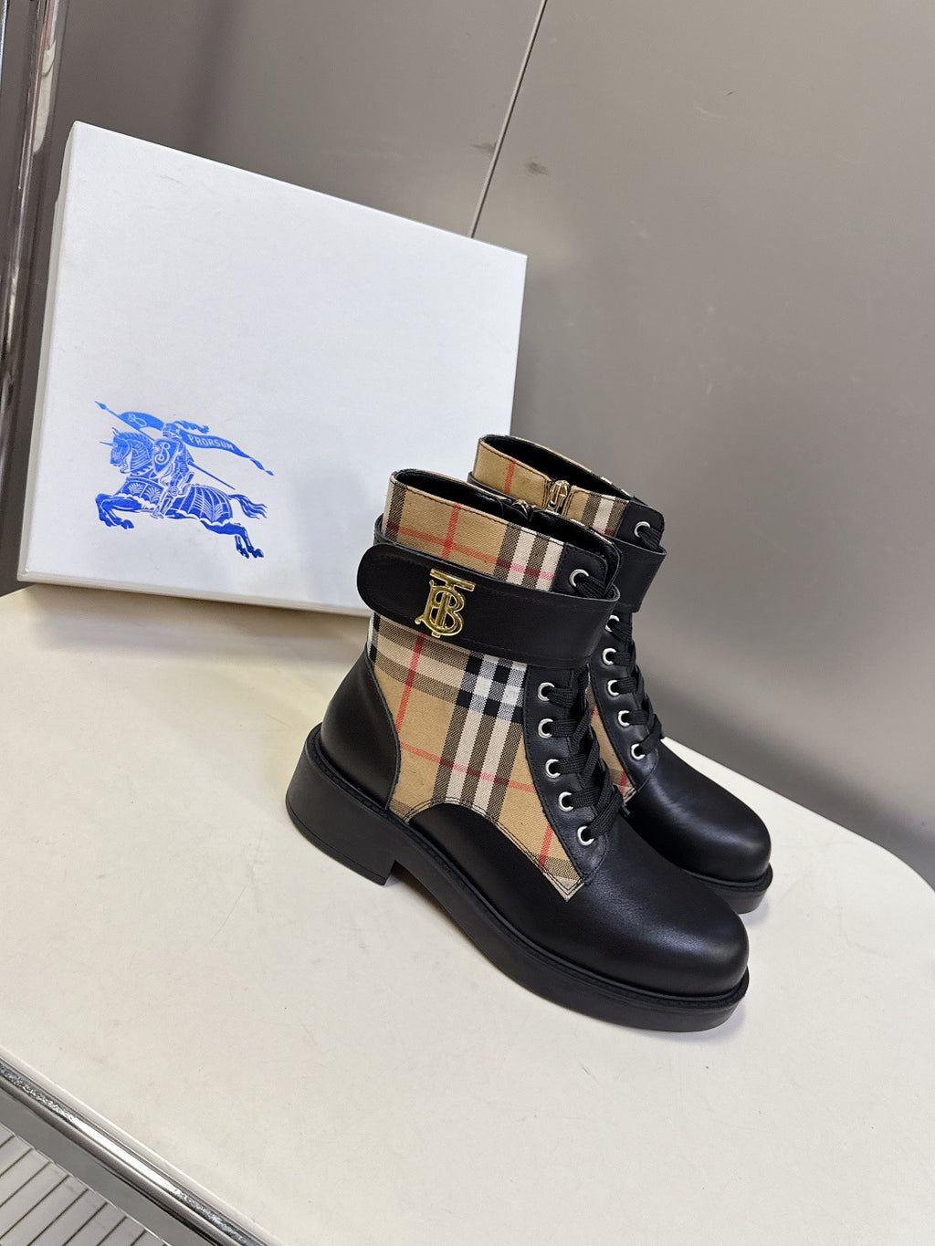 Black lace-up ankle boots with plaid side insert and gold-tone TB logo buckle