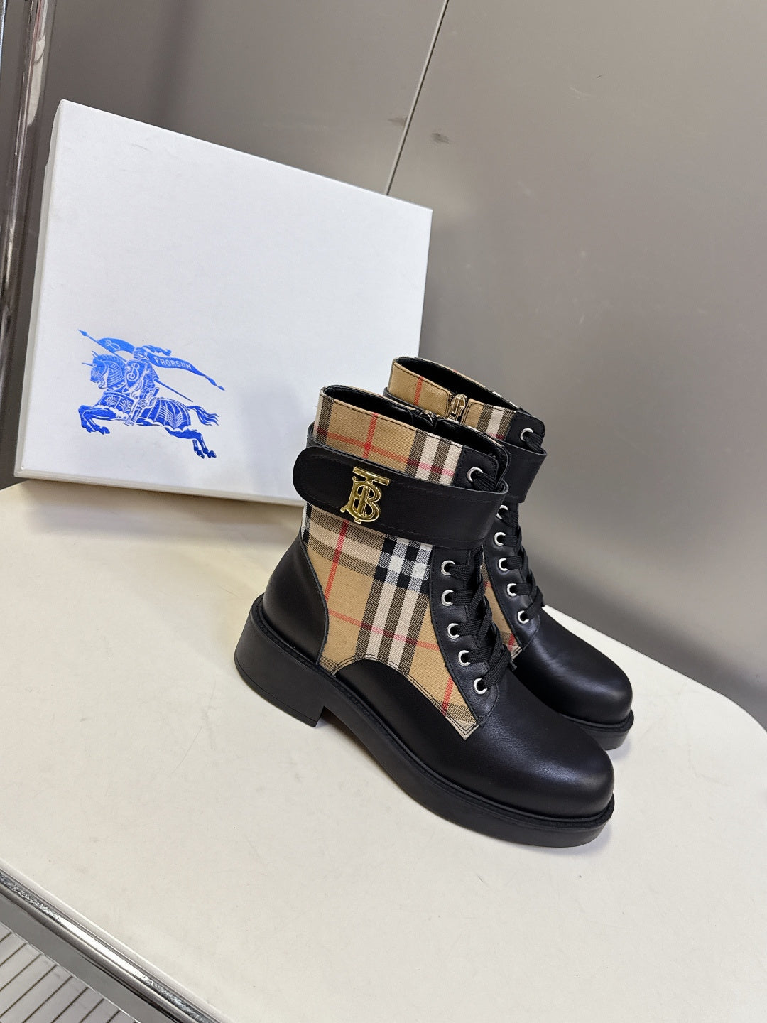 Black lace-up ankle boots with plaid side insert and gold-tone TB logo buckle
