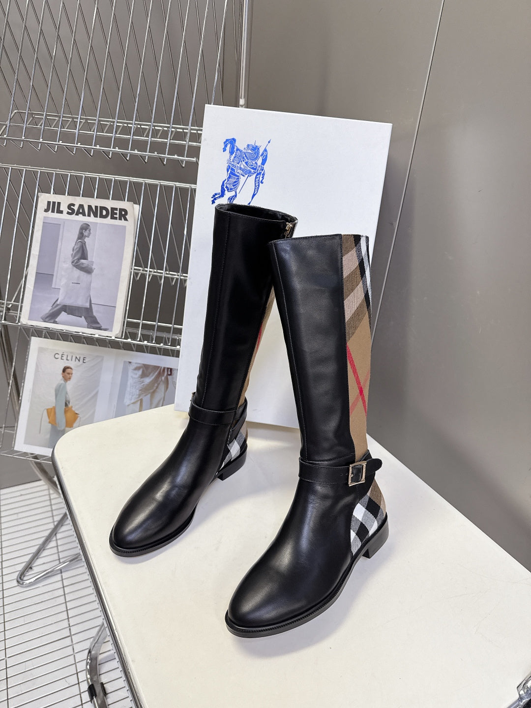 Burberry black knee-high leather boots with plaid inserts and adjustable buckle straps