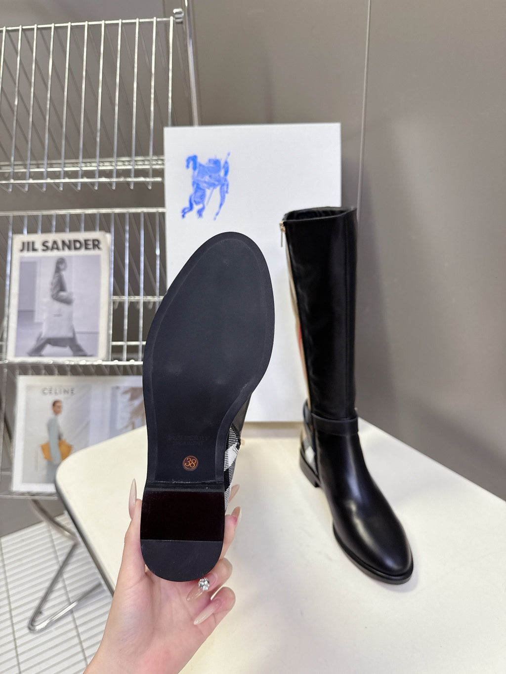 Burberry black knee-high leather boots, view of outsole and rounded toe