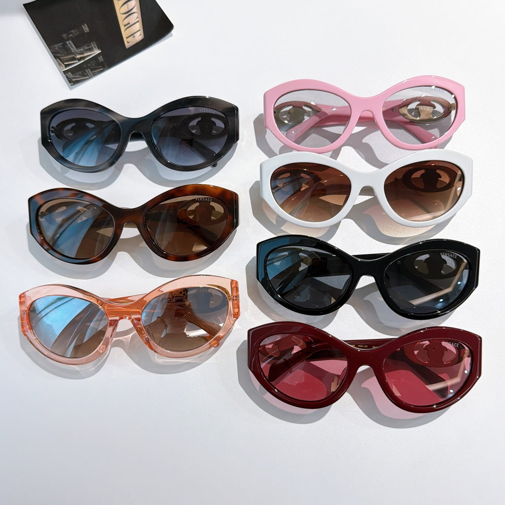 Assorted cat-eye sunglasses with tinted lenses in black, pink, brown, and red
