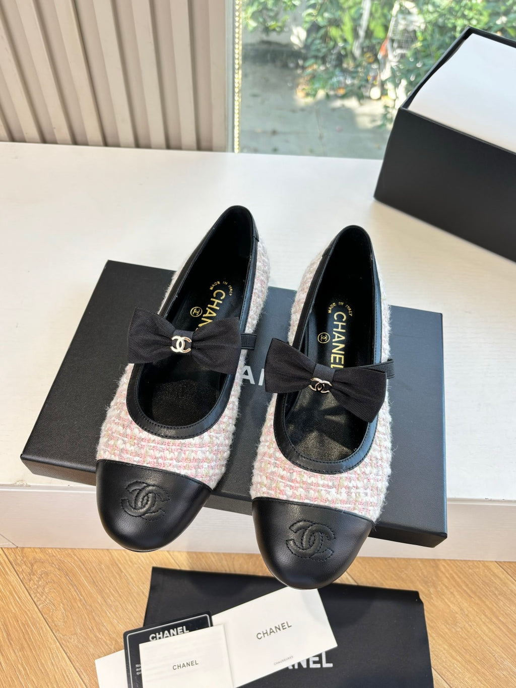 Two black and tweed ballet flats with ribbon bow and embossed logo on toe