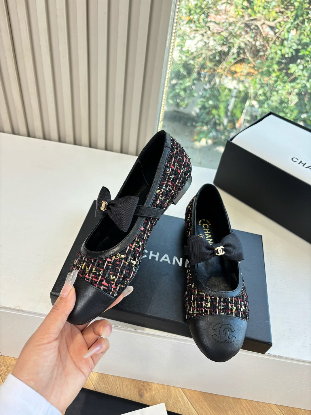 Black Chanel loafers with multicolor tweed upper and satin bow detail