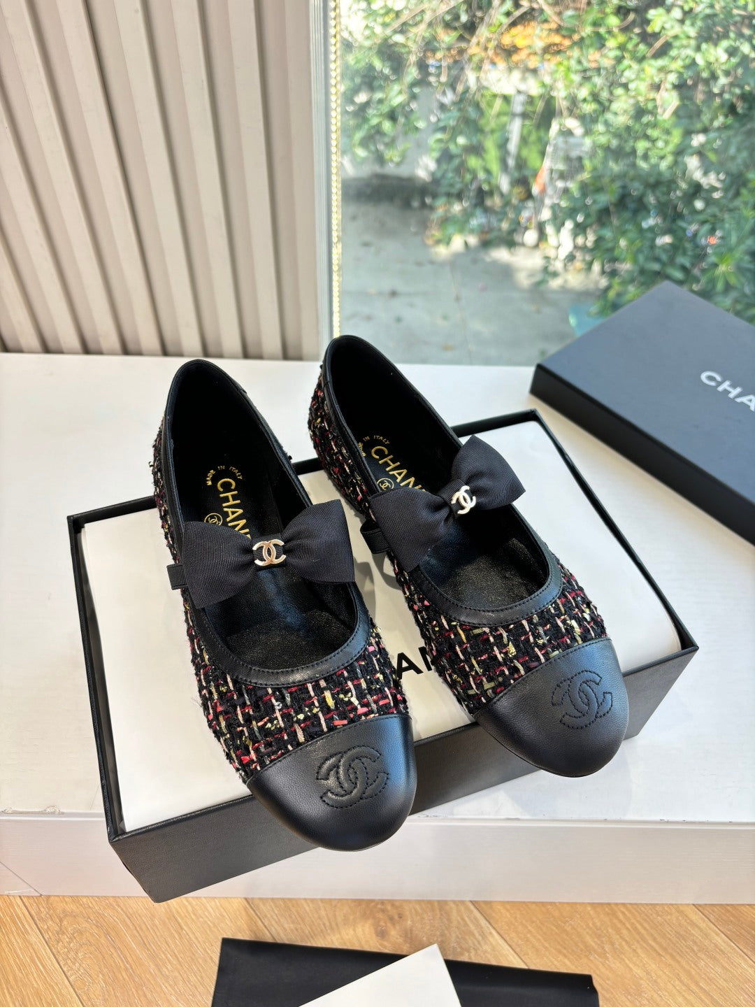 Black Chanel loafer with multicolor tweed upper, satin bow, and round toe detail