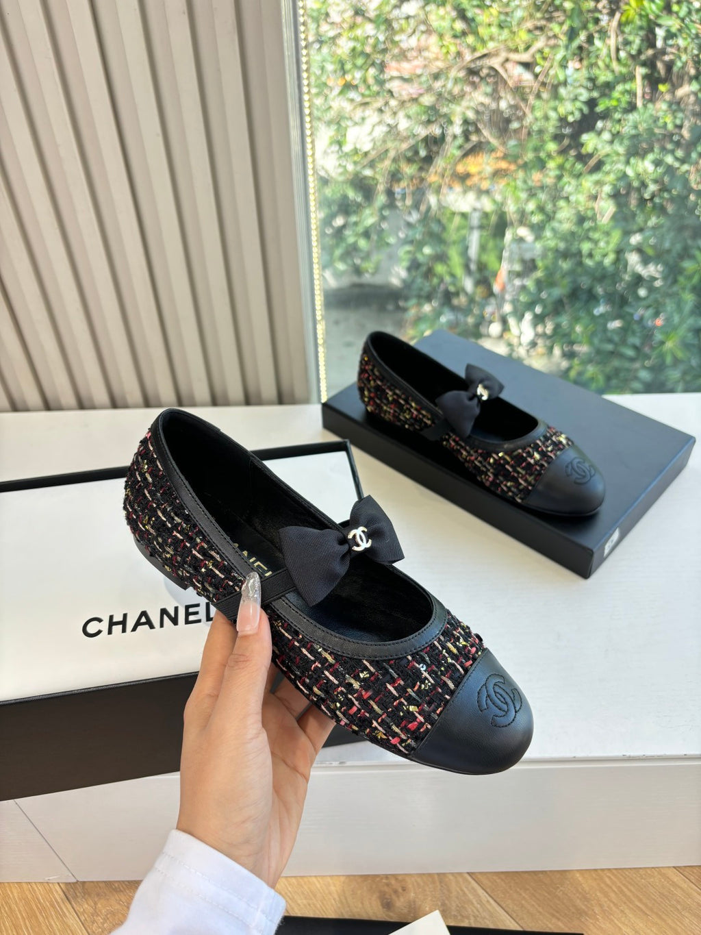 Black Chanel slip-on flats with multicolor tweed side panels and satin bow