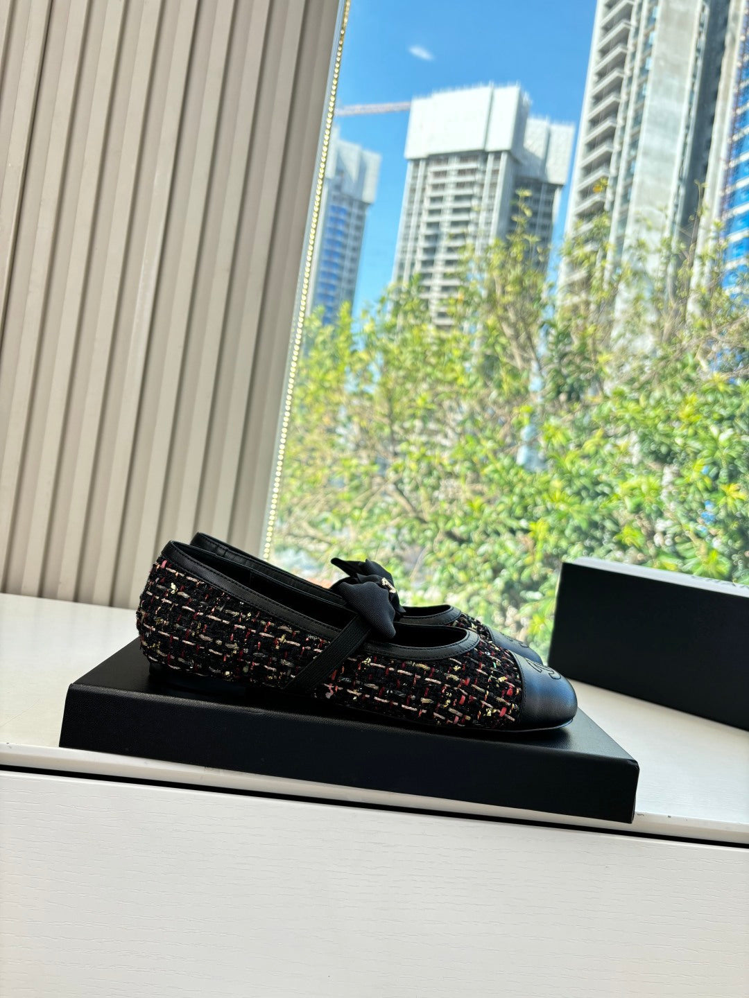 Black Chanel loafers on box, multicolor tweed upper and bow detail