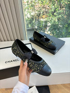 Black Chanel flats with side bow and tweed quarter panel detail