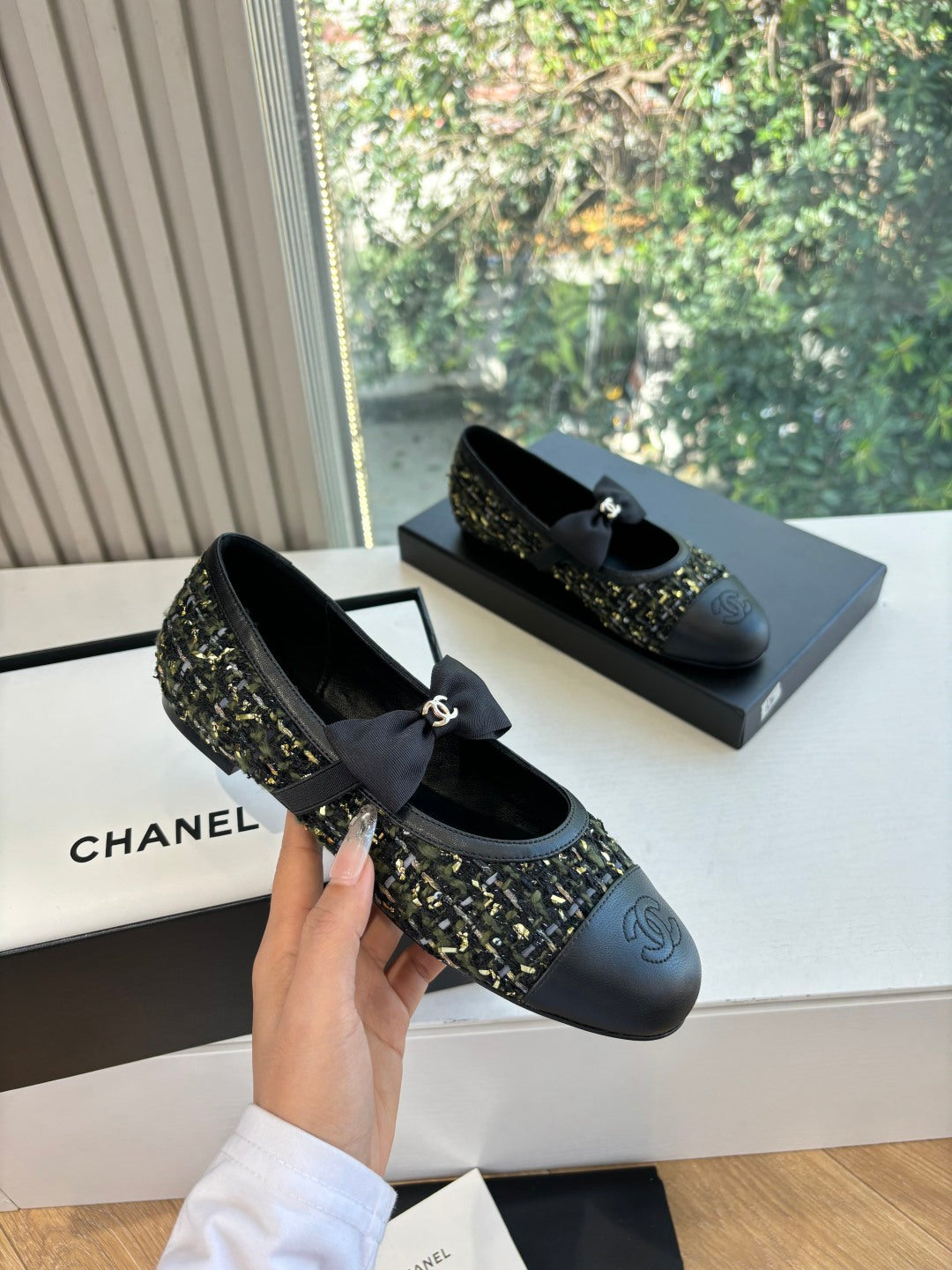 Black Chanel flats with side bow and tweed quarter panel detail