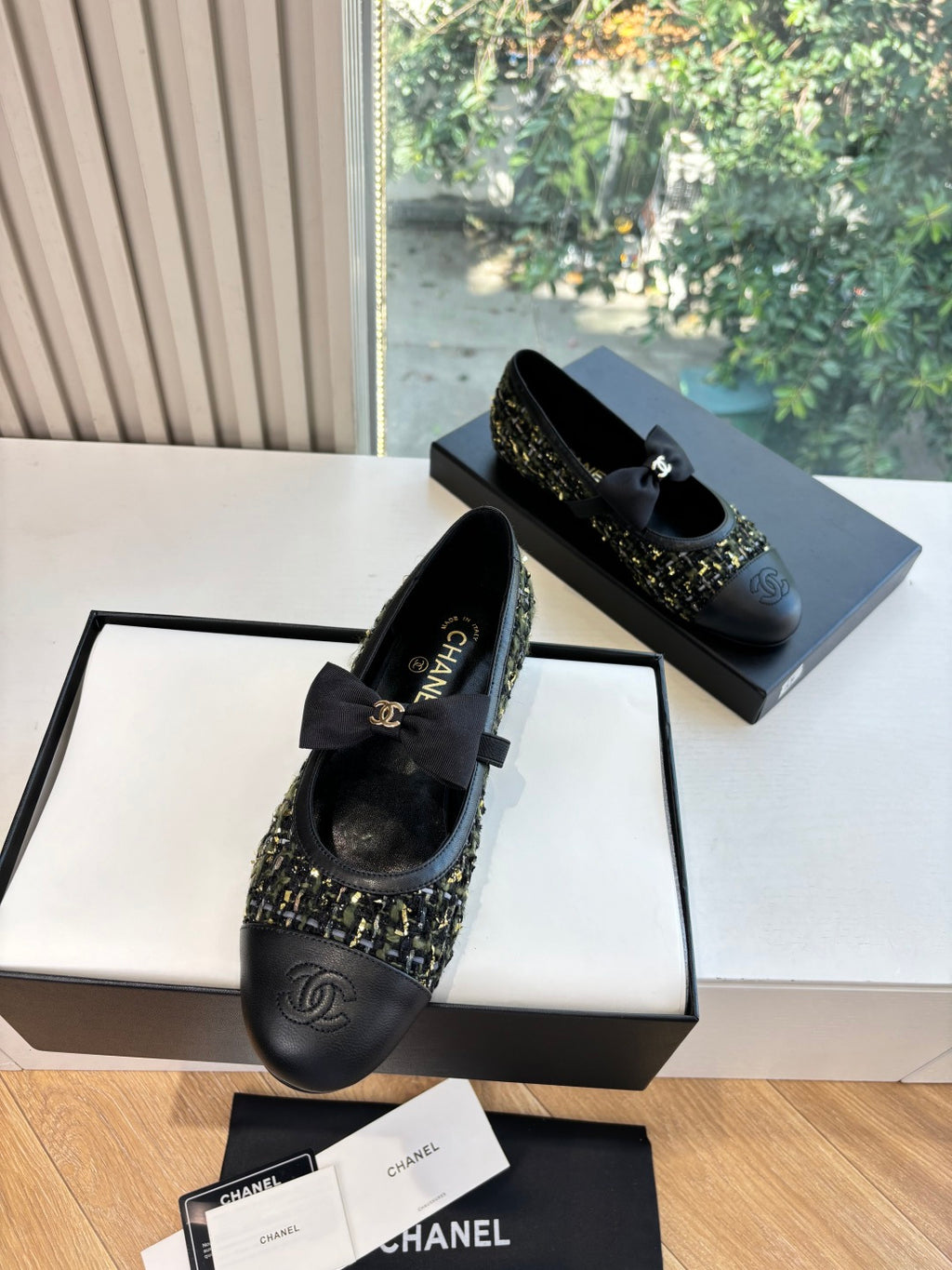 Black Chanel flats with bow detail and multicolor tweed panel on toe
