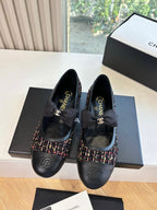 Black Chanel flats with multicolor tweed trim and bow at instep