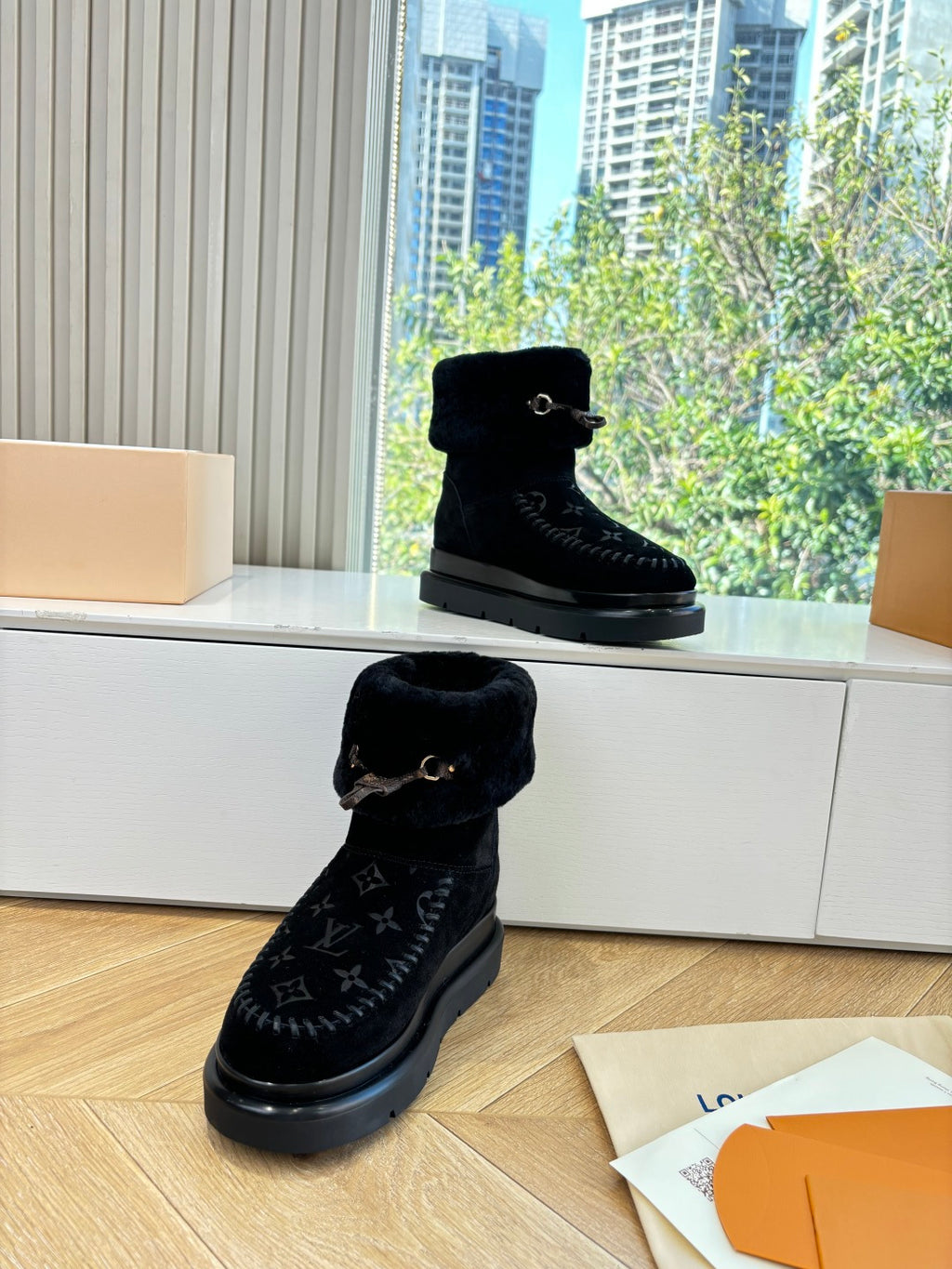 Louis Vuitton unisex black boots with fur cuff, buckle detail, and monogram shaft