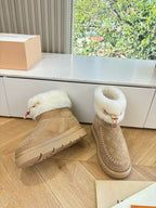 Tan suede ankle boots with white shearling lining and textured rubber sole
