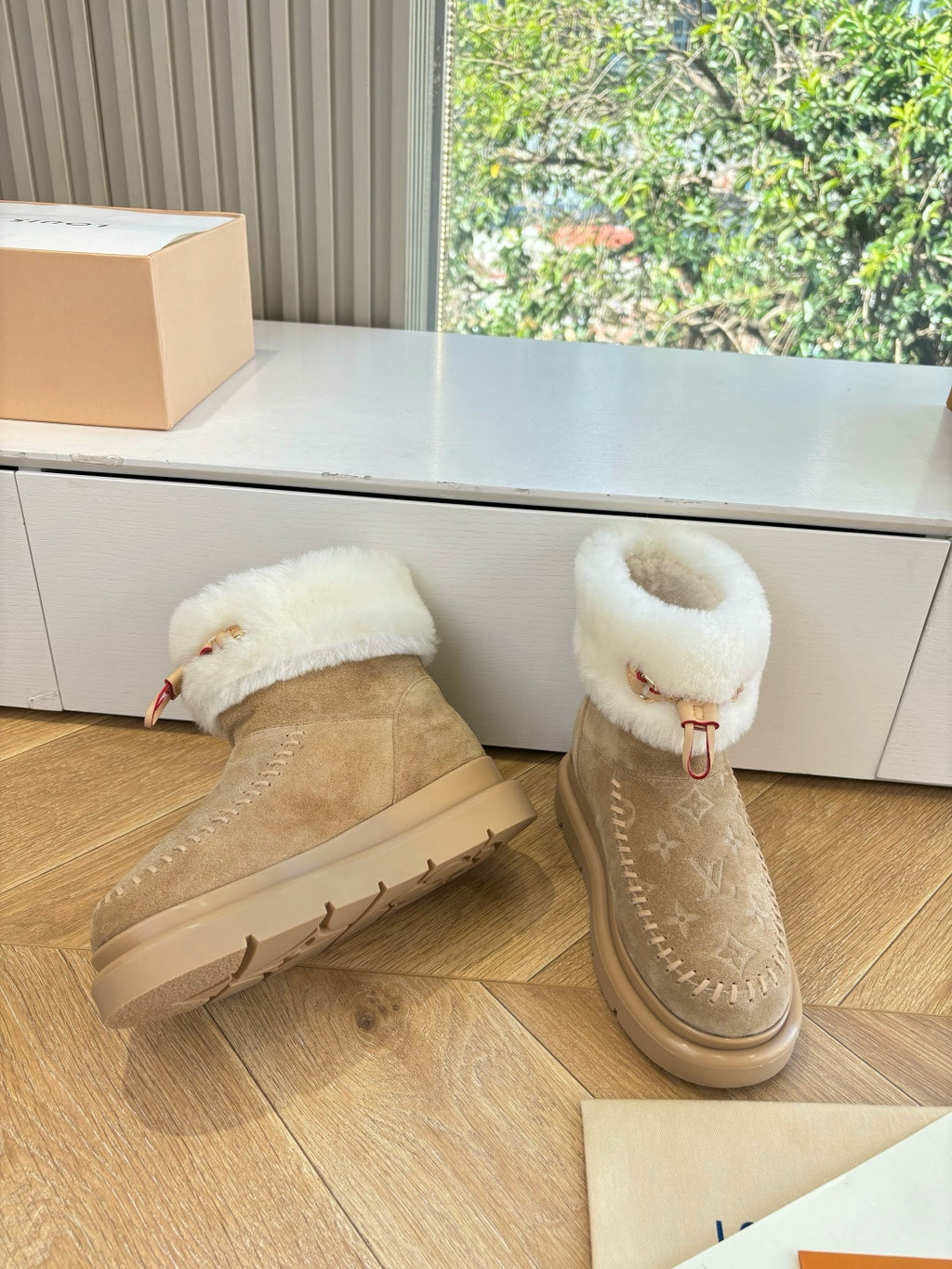 Louis Vuitton unisex ankle boots with tan suede uppers, white shearling collar, and beige sole