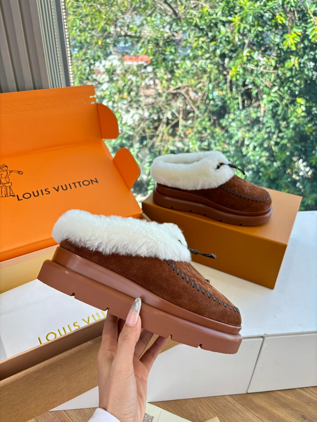 Louis Vuitton shearling suede loafers on hand, brown with white fur lining