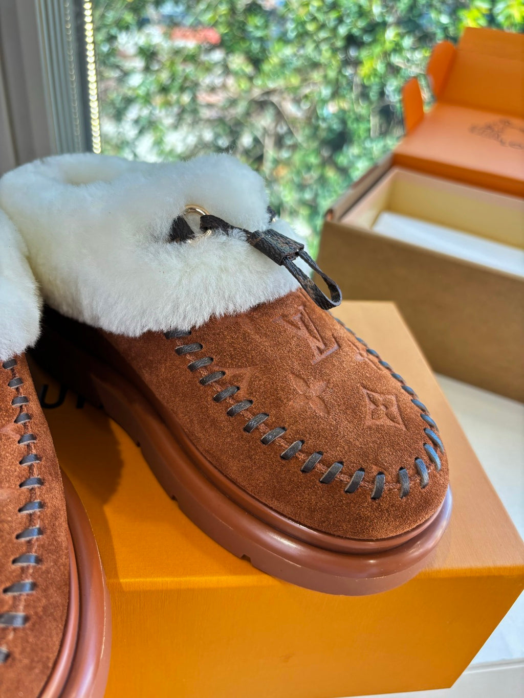 Louis Vuitton suede loafer detail, brown monogram with white shearling lining