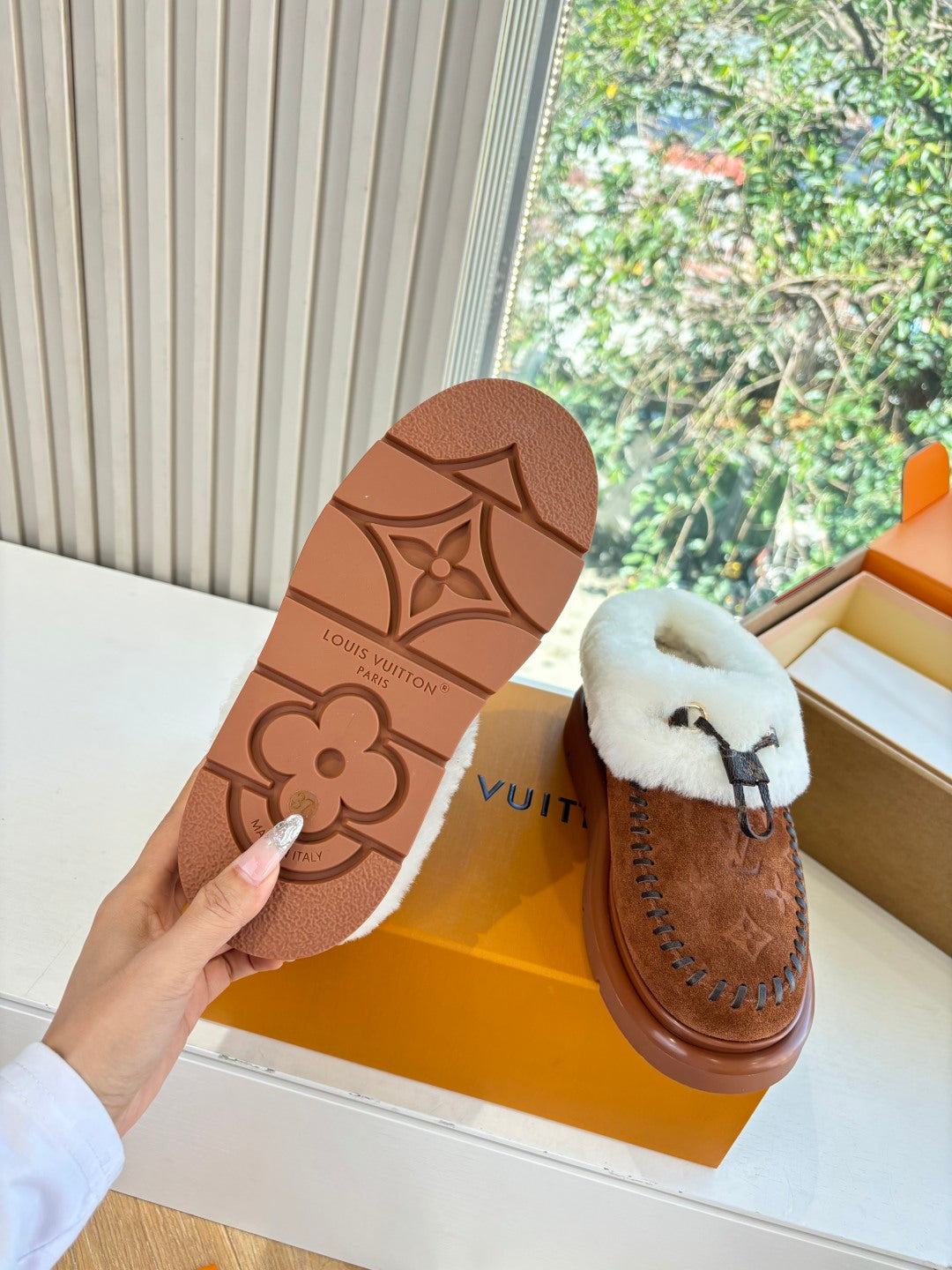 Louis Vuitton loafers suede sole view, brown rubber tread with embossed logo