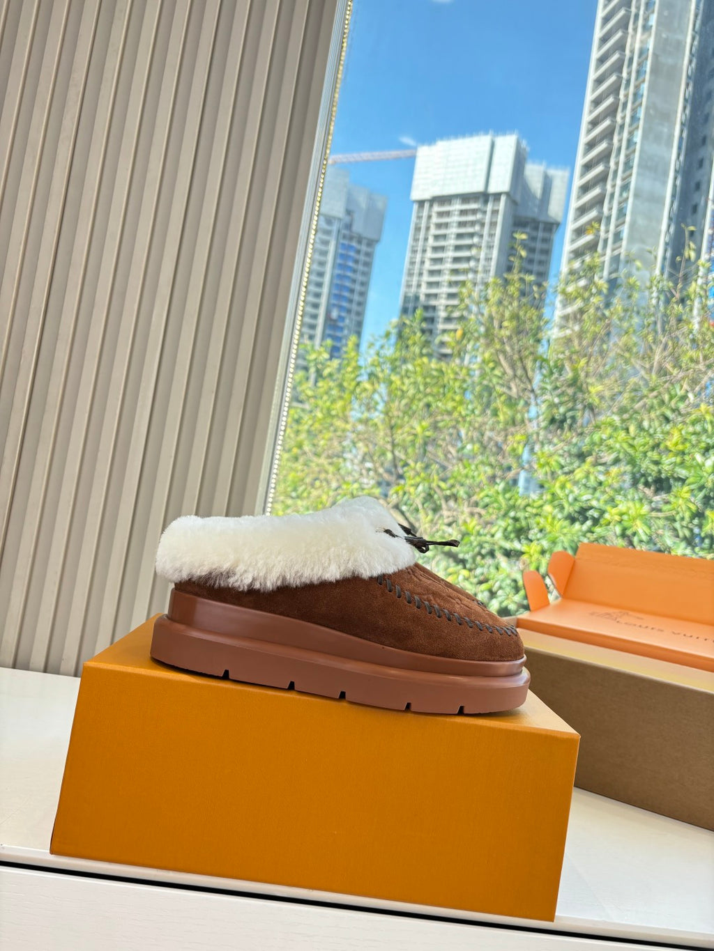 Louis Vuitton shearling loafers on box, brown suede with white fur upper