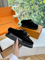 Louis Vuitton unisex black loafers with fur trim, metal buckle, and thick rubber sole