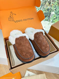 Brown monogram suede slippers with white fleece lining and black rubber sole