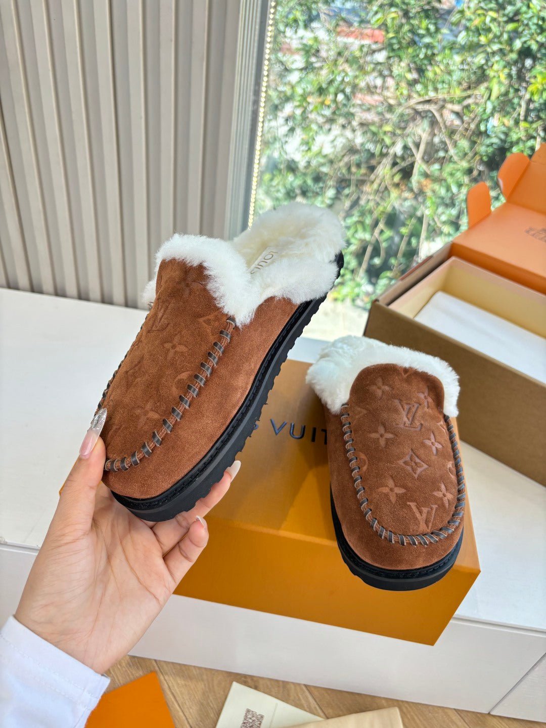 Brown monogram suede slipper with white shearling trim and black sole