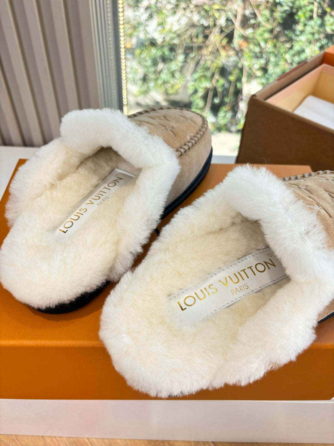Louis Vuitton shearling slide slippers, tan with white fur and printed logo