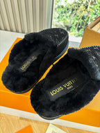 Black Louis Vuitton monogram slippers with plush lining and insole branding