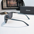 Prada sunglasses with muted blue arms and dark lenses