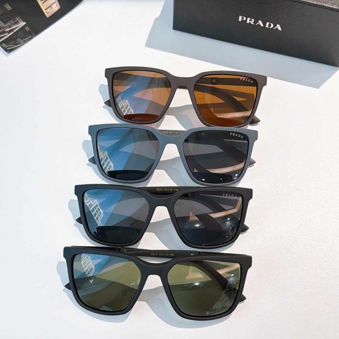 Prada sunglasses stack with amber, blue, and green-tinted lenses on dark frames