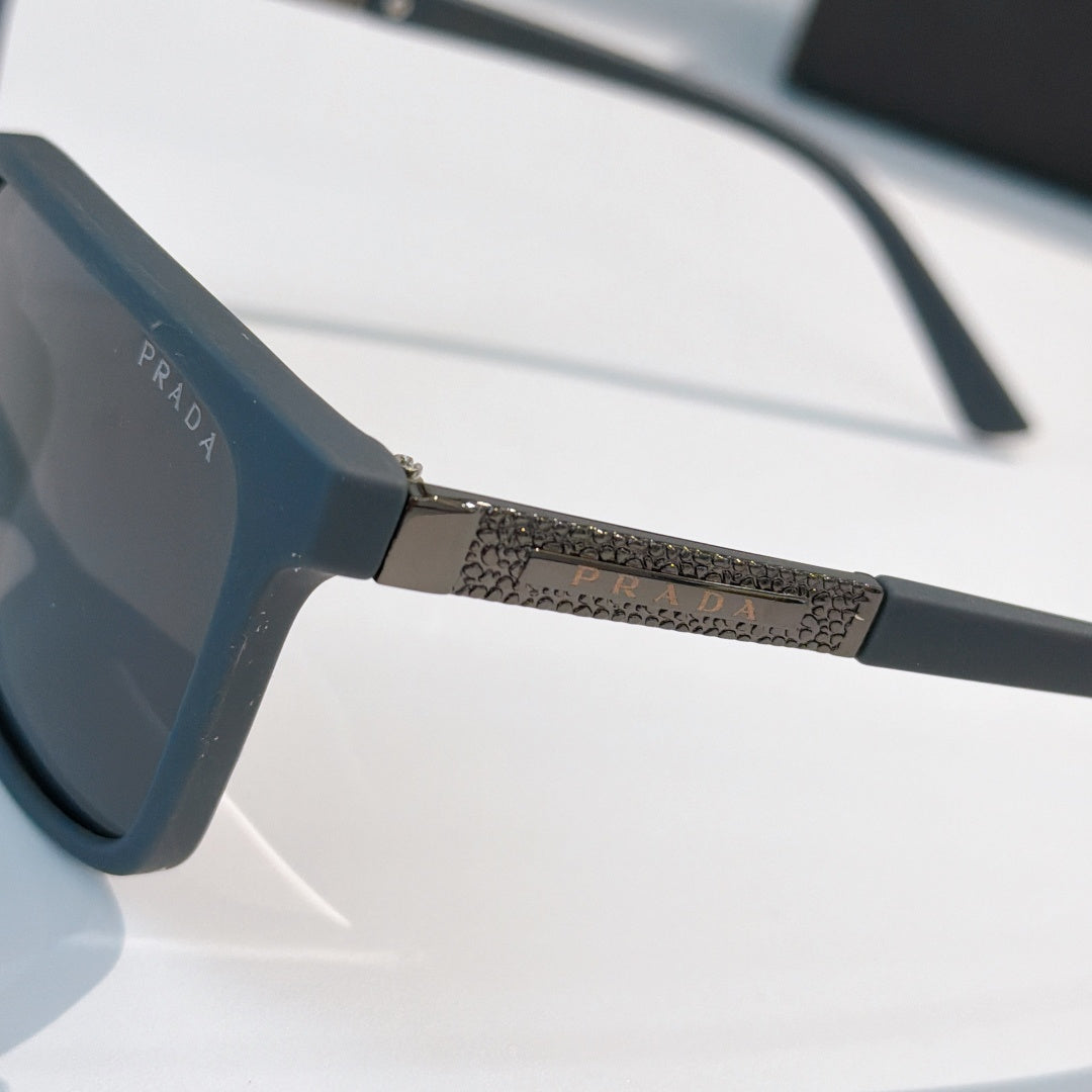 Prada sunglasses close-up, textured side bar and dark blue lens